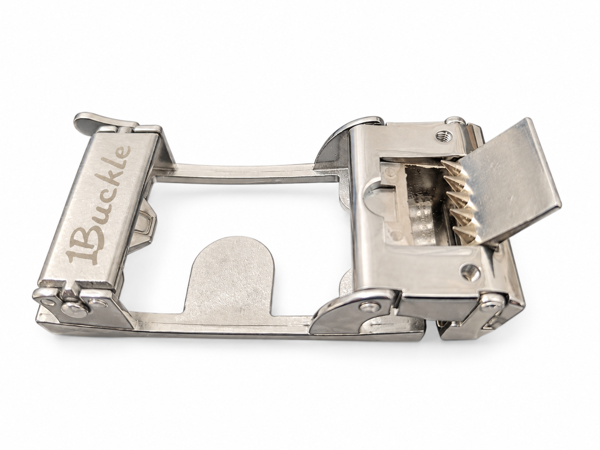 Original silver buckle showing the upper release, open gripping teeth and reinforcing screw holes